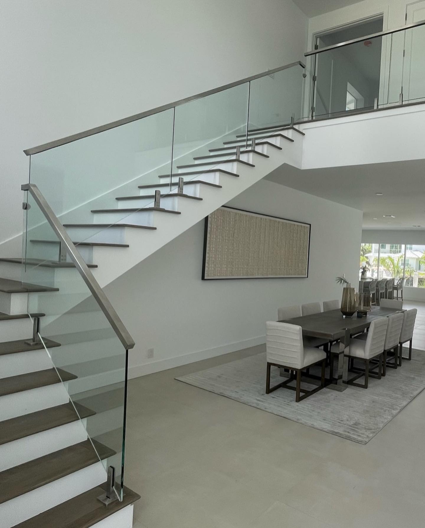 Glass railing system with brushed metal posts and hardware