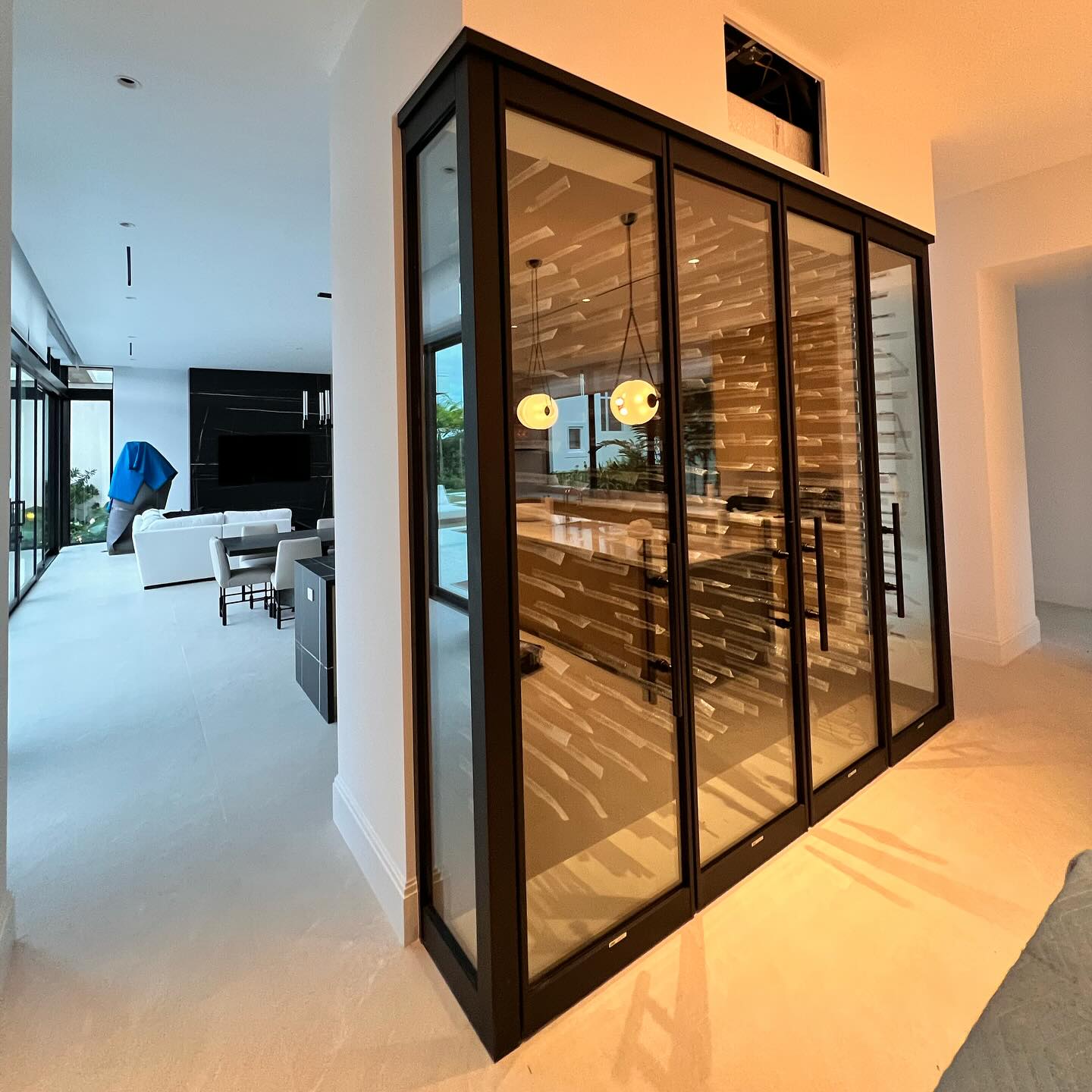 Custom wine collection displayed behind frameless glass panels
