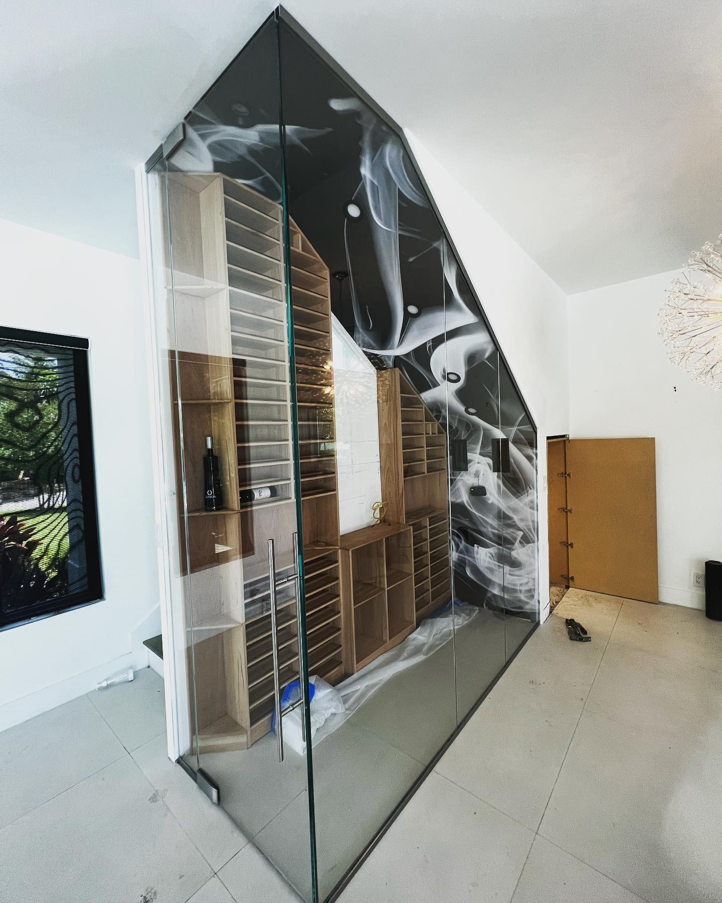 Custom residential wine room with clear glass entry