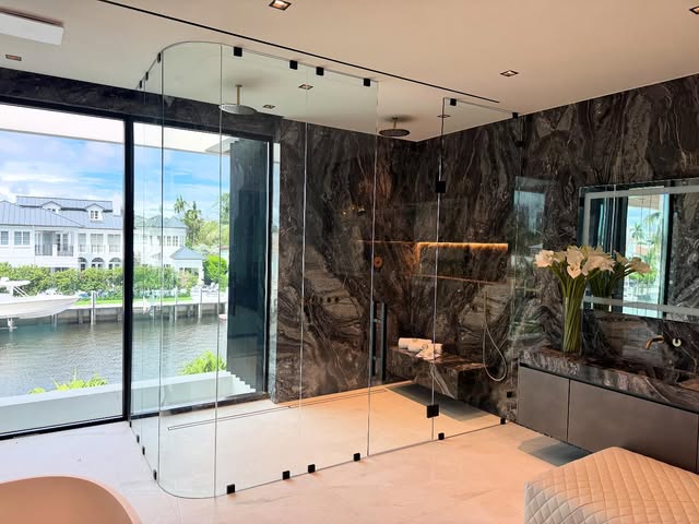 Custom curved glass shower enclosure in an Intracoastal residence