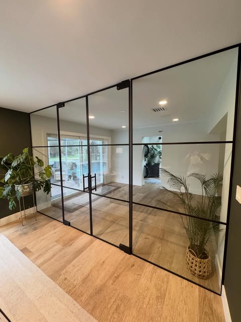 Custom glass room divider installed in a commercial interior