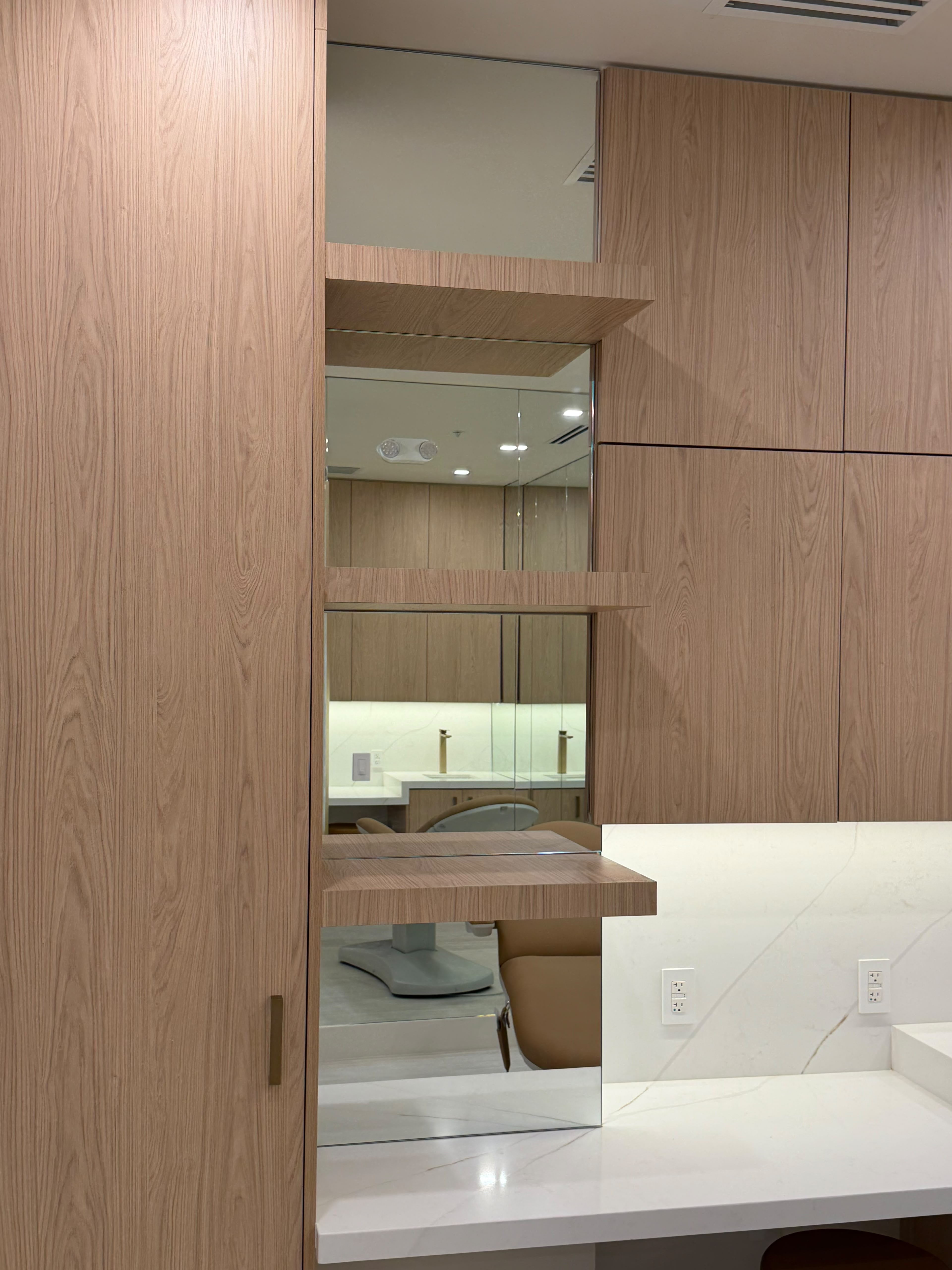 Custom glass doctor's exam room mirror wall